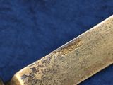 a close up of a knife on a blue cloth