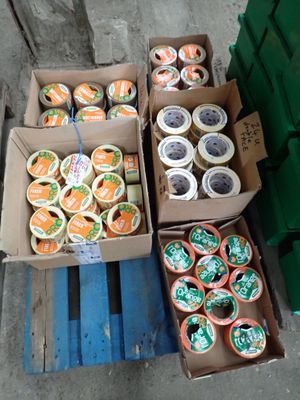 many boxes of oranges and cups of coffee on a pallet