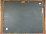 a blackboard on the wall with holes in it