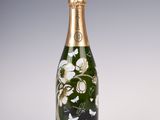 bottle of champagne with a floral design on the side