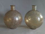 two vases sitting side by side on a white surface