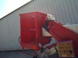 a red machine that is sitting in front of a building