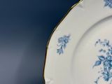 a blue and white plate with blue flowers on it