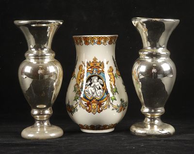 three silver vases sitting next to each other on a table