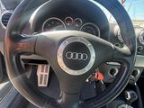steering wheel and dashboard of a car in a parking lot