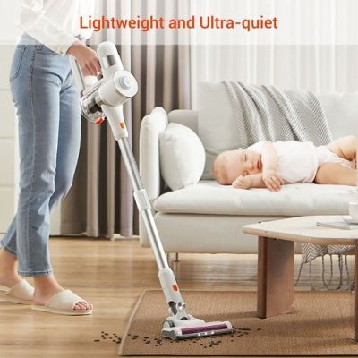 a woman that is using a vacuum to vacuum a baby