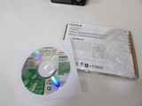 a cd sitting on top of a table next to a camera