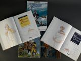 several books on a table with a drawing of a horse and carriage
