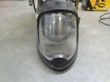 a helmet on the back of a scooter in a garage