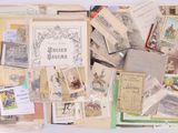 a pile of old books and postcards on a table