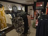 a lot of clothes that are on display in a store