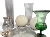 many different colored glass vases and vases on the table