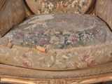 a chair that has a tapestry on the back of it