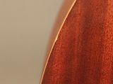 a close up of a guitar with a wooden neck and strings