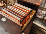 a file cabinet with a drawer full of files in a warehouse