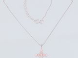 a close up of a necklace with a cross on it