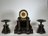 a clock sitting on top of a table next to three stools