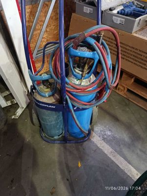 an image of a gas can with a hose attached to it