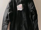 black jacket hanging on a hanger with a tag on it