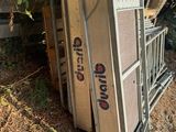 a pile of old refrigerators sitting on the ground next to a tree
