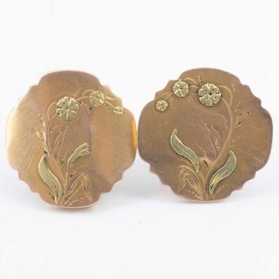 pair of antique gold plated earrings with flowers and leaves on them
