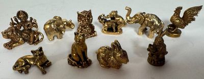 a lot of gold figurines that are on a table
