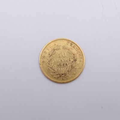 a gold coin on a white surface with a white background