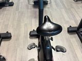 a row of stationary exercise bikes in a gym