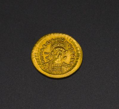 a gold coin with an image of a man on it