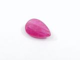 a close up of a pink stone on a white surface