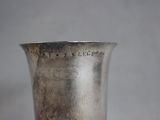 a silver vase that is sitting on a table