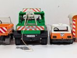 three toy trucks that are sitting next to each other