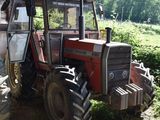 a tractor that is parked next to a building