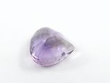 purple amethorate faceted stone on a white surface