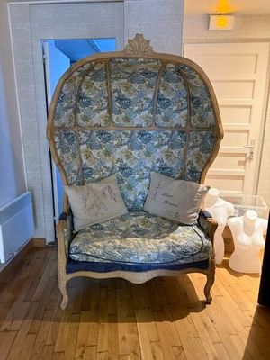 a blue and white chair in a room with wood floors