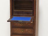 an old wooden desk with a blue top in a white room