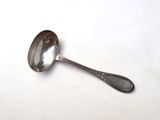 a spoon that is sitting on a white surface