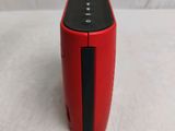 a red and black speaker sitting on a white surface