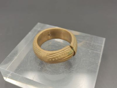 une bague en or posée sur le dessus d'une vitrine transparente