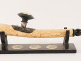 an image of a pen with a wooden handle on a stand