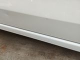 a picture of a white car parked in a parking lot