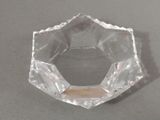 a clear glass bowl on a table with a white background