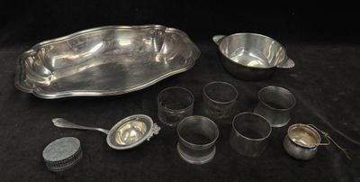 a lot of silver spoons and bowls on the table