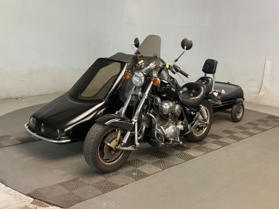 une moto noire avec un side-car garée à côté