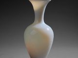 a white vase that is sitting on a table