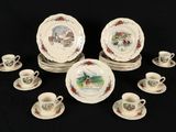 a lot of plates and cups on a black table