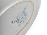 a white plate with a drawing on it sitting on a table