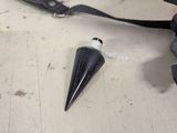 a small black object on a table next to a pair of scissors