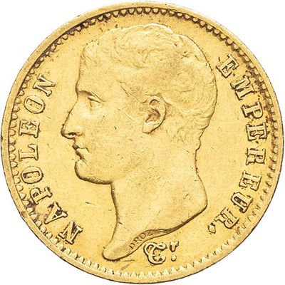 a close up of a gold coin with a man ' s face