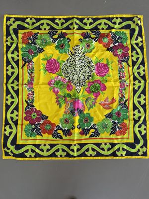 an image of a yellow and black square scarf with flowers and leaves on it